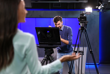 Photo of Professional video camera operator working in studio