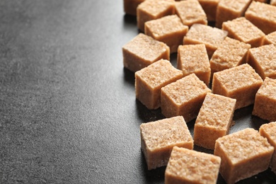 Cubes of brown sugar on table Photo of Cubes of brown sugar on table