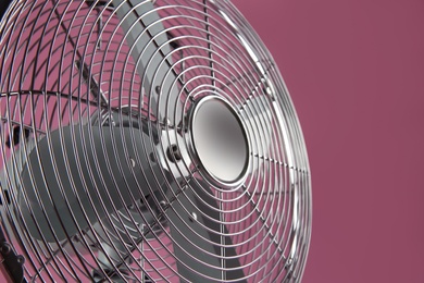 Modern electric fan on pink background, closeup Photo of Modern electric fan on pink background, closeup