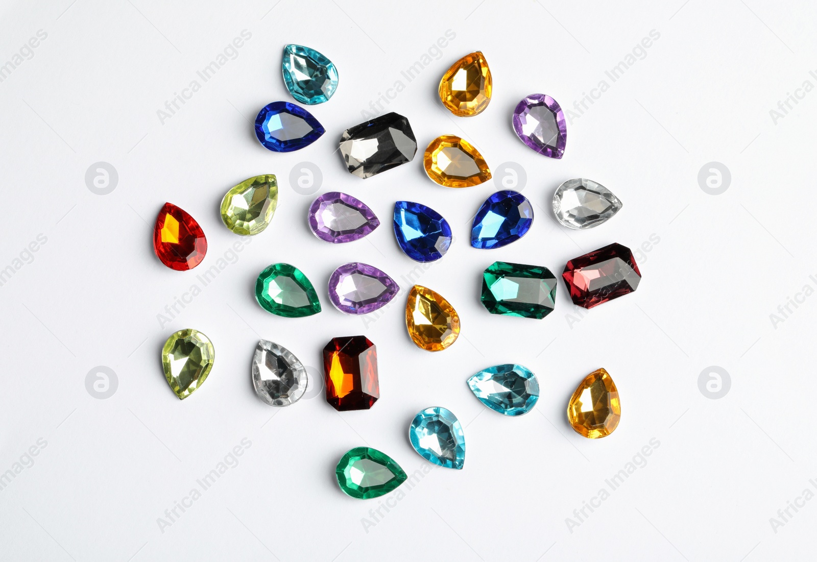 Different beautiful gemstones on white background, top view Image of Different beautiful gemstones on white background, top view