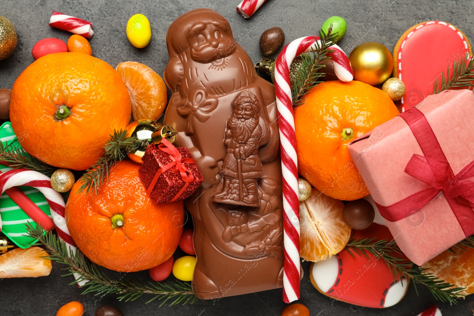 Flat lay composition with chocolate Santa Claus candies on table, closeup Photo of Flat lay composition with chocolate Santa Claus candies on table, closeup