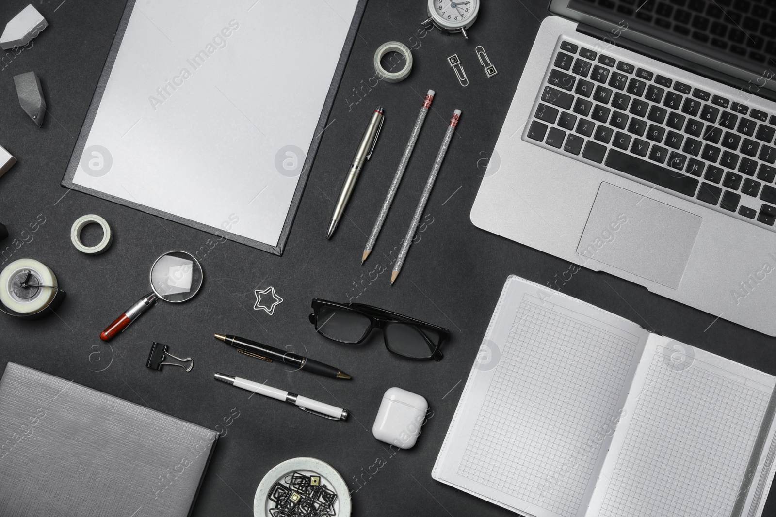 Flat lay composition with laptop and stationery on black background. Designer's workplace Photo of Flat lay composition with laptop and stationery on black background. Designer's workplace