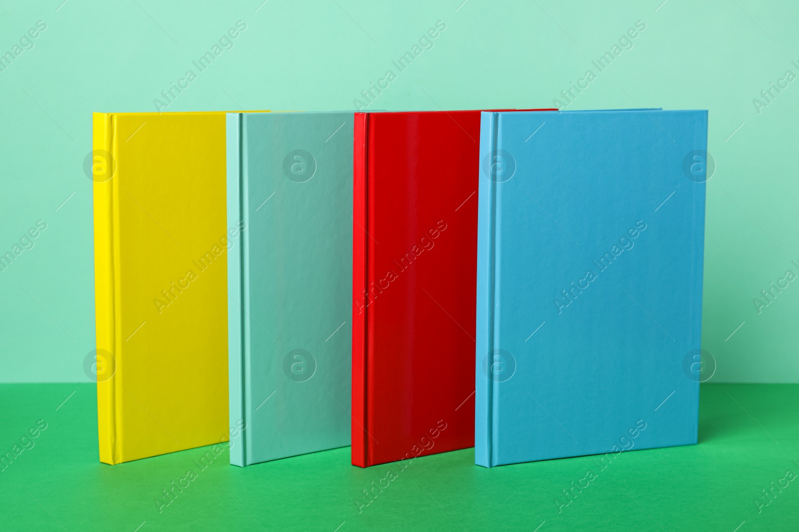 New stylish bright planners on color background Photo of New stylish bright planners on color background