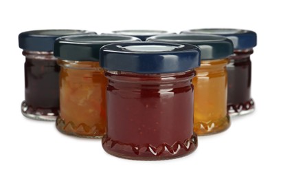 Jars with different jams on white background Photo of Jars with different jams on white background