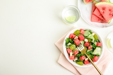 Delicious salad with watermelon served on white table, flat lay. Space for text Photo of Delicious salad with watermelon served on white table, flat lay. Space for text