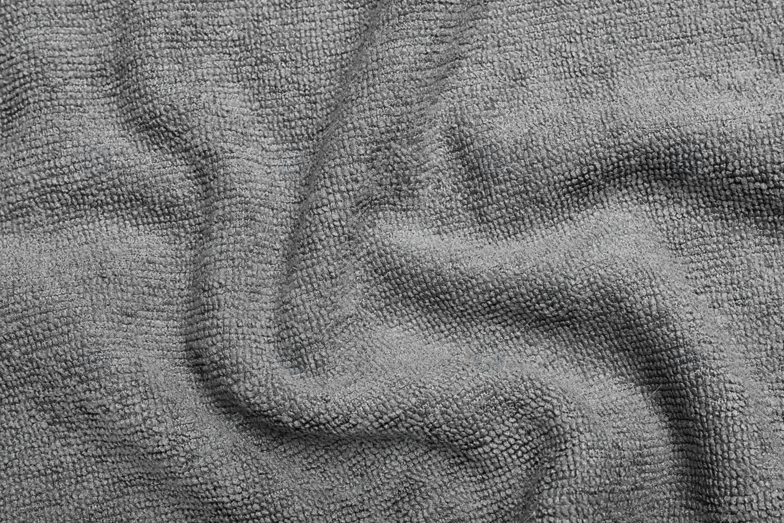 Crumpled grey microfiber cloth as background, closeup Photo of Crumpled grey microfiber cloth as background, closeup