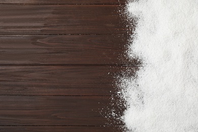 Artificial snow on wooden background, top view with space for text. Christmas decor Photo of Artificial snow on wooden background, top view with space for text. Christmas decor