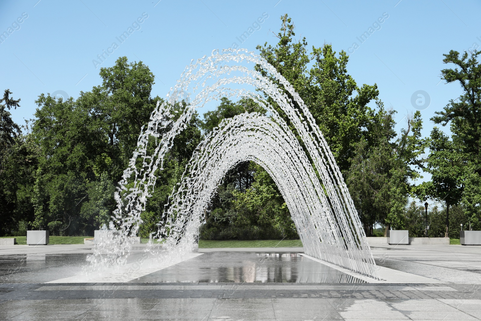 Photo of City square with beautiful fountains on sunny day