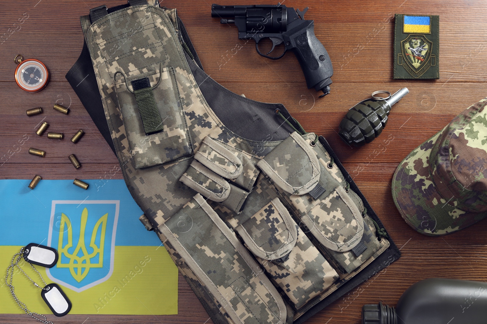 MYKOLAIV, UKRAINE - SEPTEMBER 26, 2020: Tactical gear and Ukrainian flag on table, flat lay Photo of MYKOLAIV, UKRAINE - SEPTEMBER 26, 2020: Tactical gear and Ukrainian flag on table, flat lay