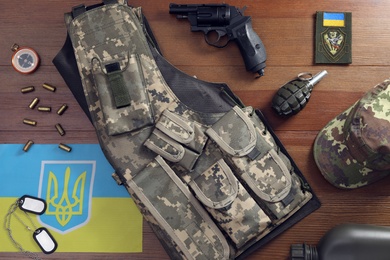MYKOLAIV, UKRAINE - SEPTEMBER 26, 2020: Tactical gear and Ukrainian flag on table, flat lay Photo of MYKOLAIV, UKRAINE - SEPTEMBER 26, 2020: Tactical gear and Ukrainian flag on table, flat lay