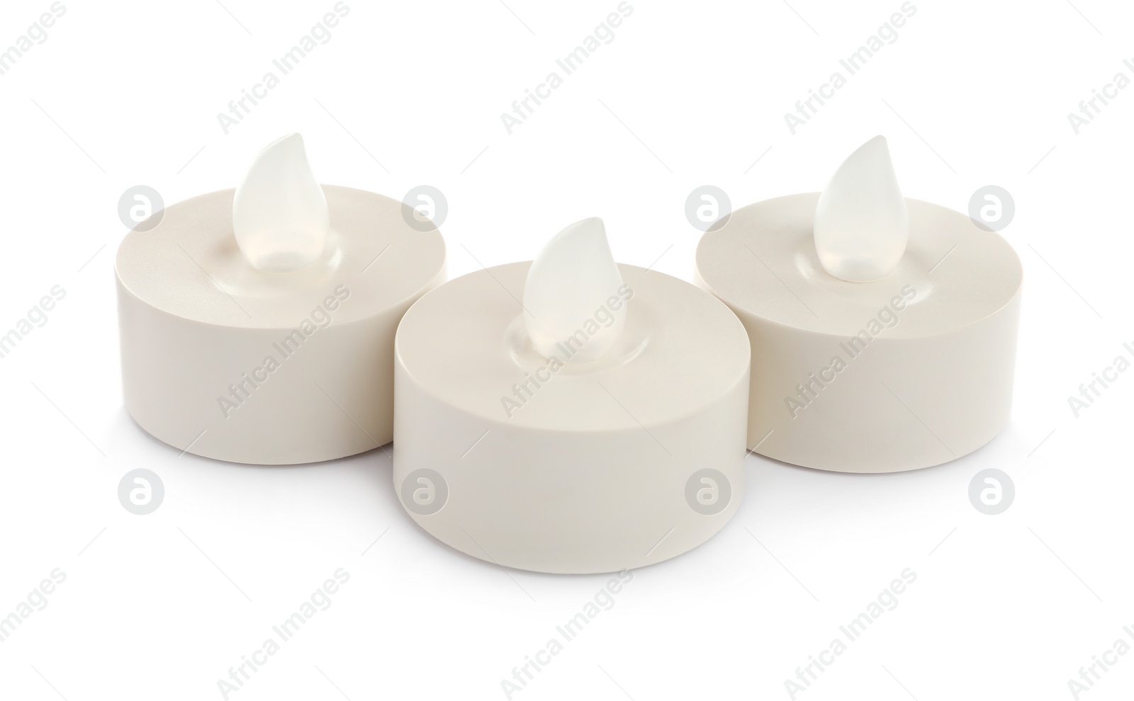 Decorative flameless LED candles on white background Photo of Decorative flameless LED candles on white background