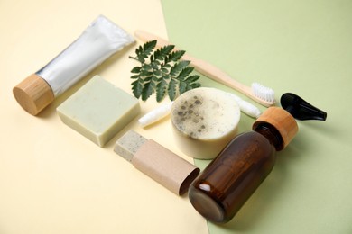 Eco friendly personal care products and green leaf on color background Photo of Eco friendly personal care products and green leaf on color background