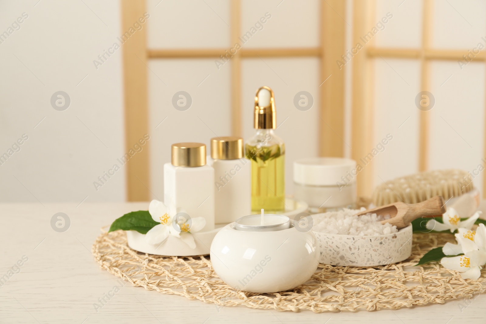 Composition with beautiful jasmine flowers and skin care products on white wooden table indoors Photo of Composition with beautiful jasmine flowers and skin care products on white wooden table indoors