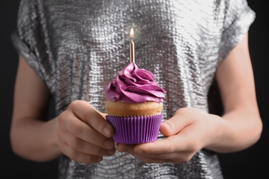 Woman holding birthday cupcake, closeup Photo of Woman holding birthday cupcake, closeup