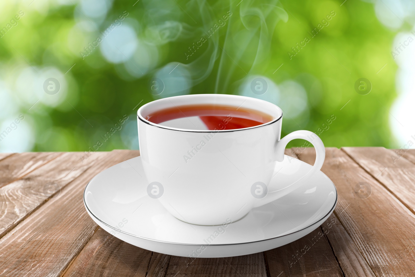 Cup of hot freshly brewed rooibos tea on wooden table outdoors Image of Cup of hot freshly brewed rooibos tea on wooden table outdoors