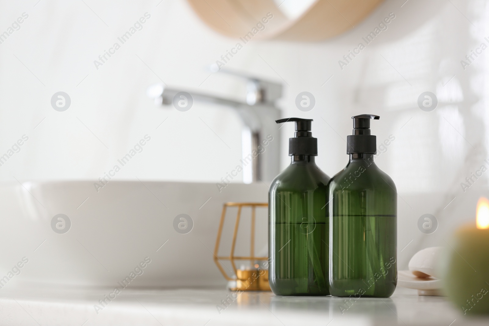 Green soap dispensers on countertop near sink in bathroom. Space for text Photo of Green soap dispensers on countertop near sink in bathroom. Space for text