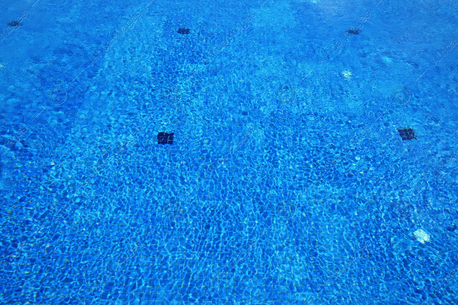 Outdoor swimming pool with clear water on sunny day Photo of Outdoor swimming pool with clear water on sunny day