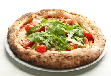 Tasty pizza with meat and arugula on white table, closeup Photo of Tasty pizza with meat and arugula on white table, closeup