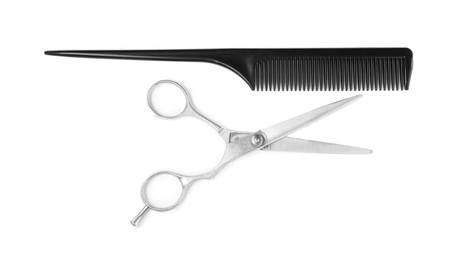 Professional hairdresser scissors and black comb isolated on white, top view. Haircut tools Photo of Professional hairdresser scissors and black comb isolated on white, top view. Haircut tools