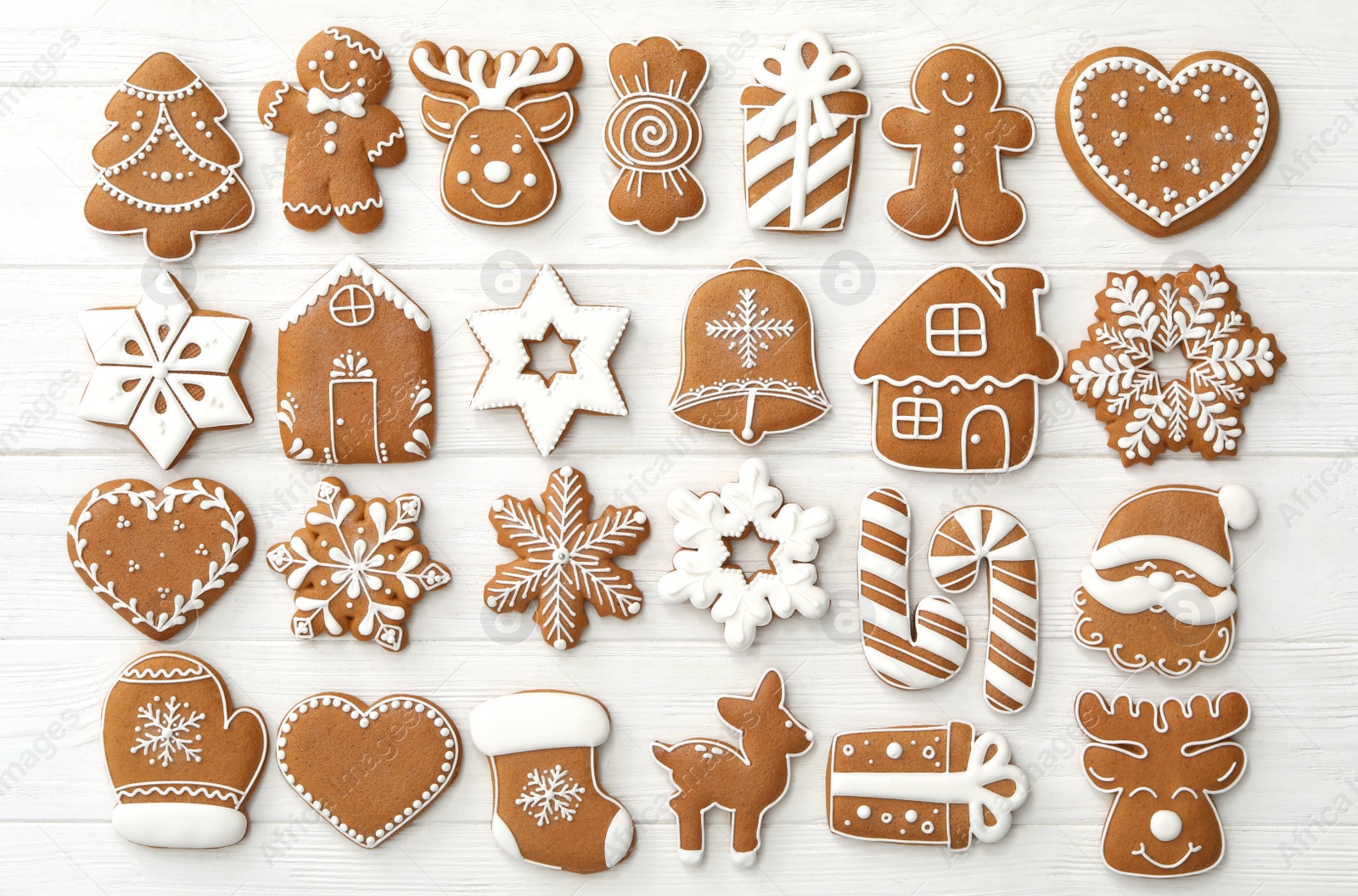 Photo of Many different delicious Christmas cookies on white wooden table, flat lay