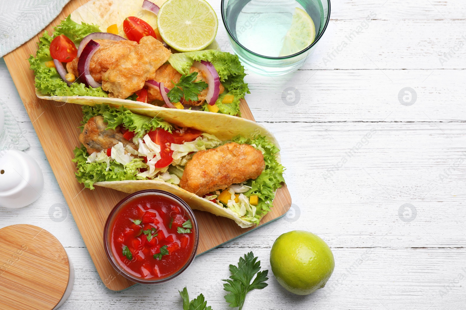 Delicious fish tacos served on white wooden table, flat lay Photo of Delicious fish tacos served on white wooden table, flat lay