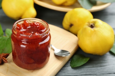 Delicious quince jam on grey wooden table, closeup Photo of Delicious quince jam on grey wooden table, closeup