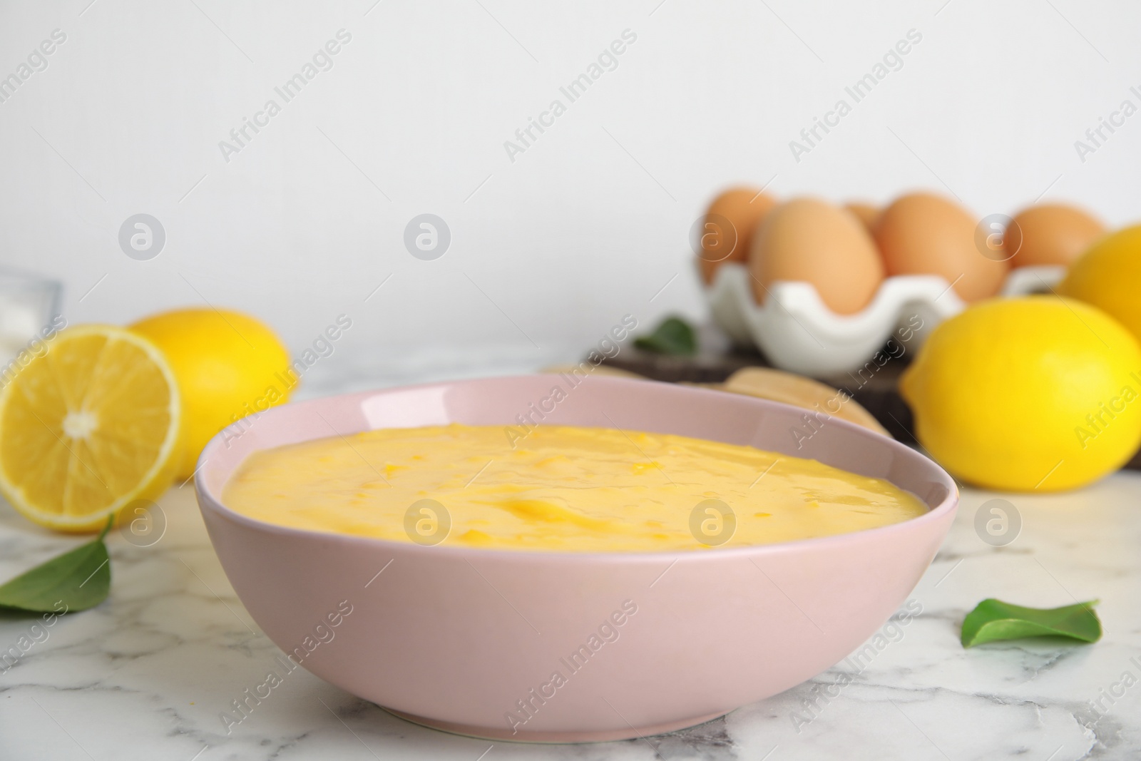 Delicious lemon curd on white marble table Photo of Delicious lemon curd on white marble table