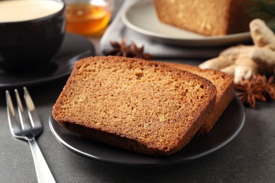 Fresh gingerbread cake slices served on grey table, closeup Photo of Fresh gingerbread cake slices served on grey table, closeup