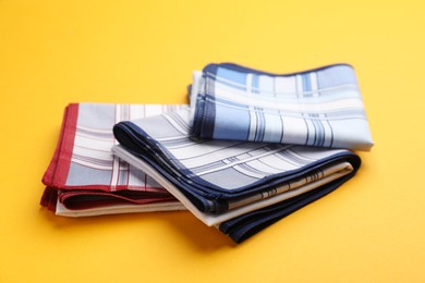 Different new stylish handkerchiefs on yellow background Photo of Different new stylish handkerchiefs on yellow background