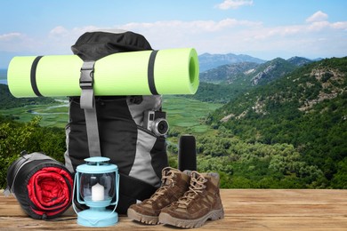 Camping equipment for tourist on wooden surface and beautiful view of mountain landscape Image of Camping equipment for tourist on wooden surface and beautiful view of mountain landscape