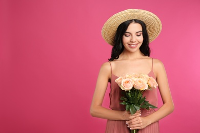 Portrait of smiling woman with beautiful bouquet on pink background. Space for text Photo of Portrait of smiling woman with beautiful bouquet on pink background. Space for text