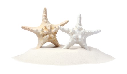 Beautiful sea stars in sand on white background Photo of Beautiful sea stars in sand on white background