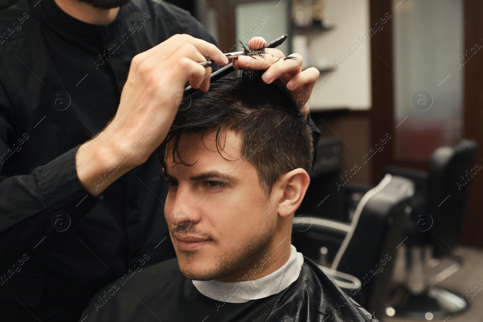 Professional hairdresser making stylish haircut in salon, closeup Photo of Professional hairdresser making stylish haircut in salon, closeup