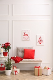 Christmas themed pictures in bright room with festive decorations. Interior design Photo of Christmas themed pictures in bright room with festive decorations. Interior design