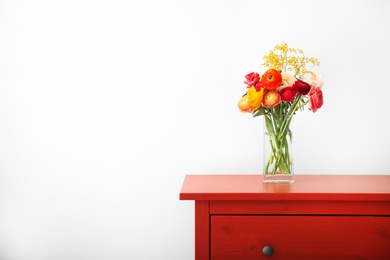 Vase with beautiful ranunculus flowers indoors Photo of Vase with beautiful ranunculus flowers indoors