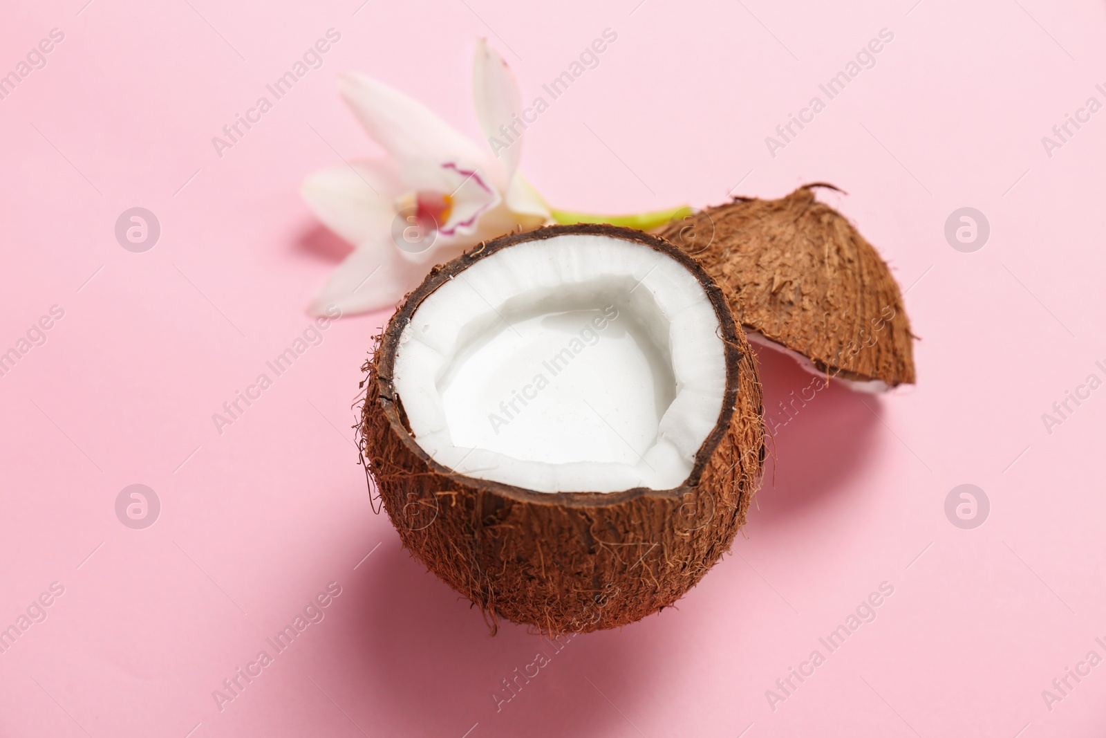 Nut with fresh coconut milk on color background Photo of Nut with fresh coconut milk on color background