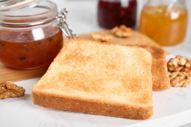 Toasts, sea buckthorn jam and walnuts for breakfast on table, closeup Image of Toasts, sea buckthorn jam and walnuts for breakfast on table, closeup