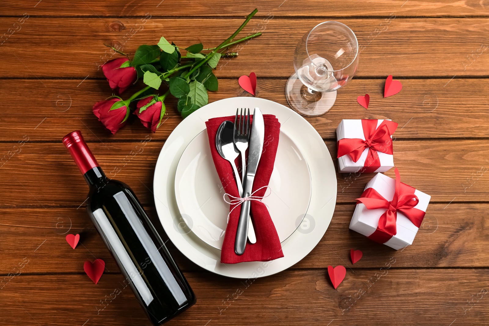 Beautiful table setting for Valentine's Day dinner on wooden background, flat lay Photo of Beautiful table setting for Valentine's Day dinner on wooden background, flat lay