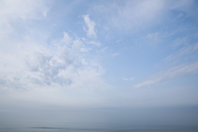 Picturesque view of beautiful blue sky with white clouds over sea Photo of Picturesque view of beautiful blue sky with white clouds over sea