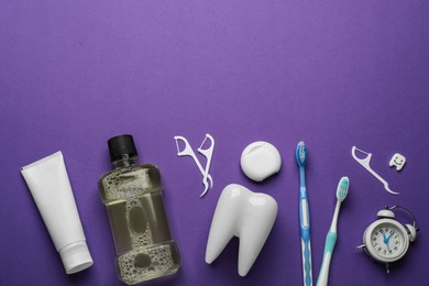 Flat lay composition with mouthwash and other oral hygiene products on purple background. Space for text Photo of Flat lay composition with mouthwash and other oral hygiene products on purple background. Space for text