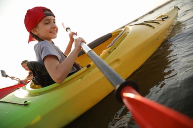 Little children kayaking on river. Summer camp activity Photo of Little children kayaking on river. Summer camp activity