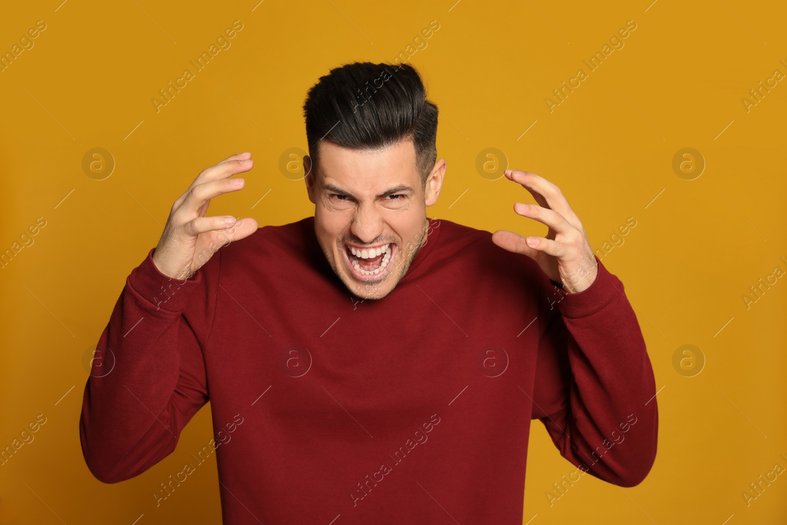 Angry man on yellow background. Hate concept Photo of Angry man on yellow background. Hate concept