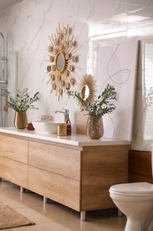 Modern bathroom interior with stylish mirror and vessel sink Photo of Modern bathroom interior with stylish mirror and vessel sink