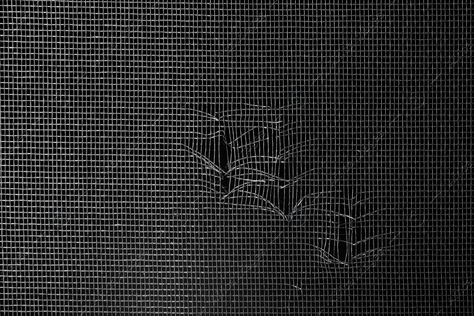 Torn window screen against black background, closeup Photo of Torn window screen against black background, closeup