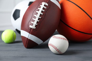 Set of different sport balls on grey wooden table, closeup Photo of Set of different sport balls on grey wooden table, closeup