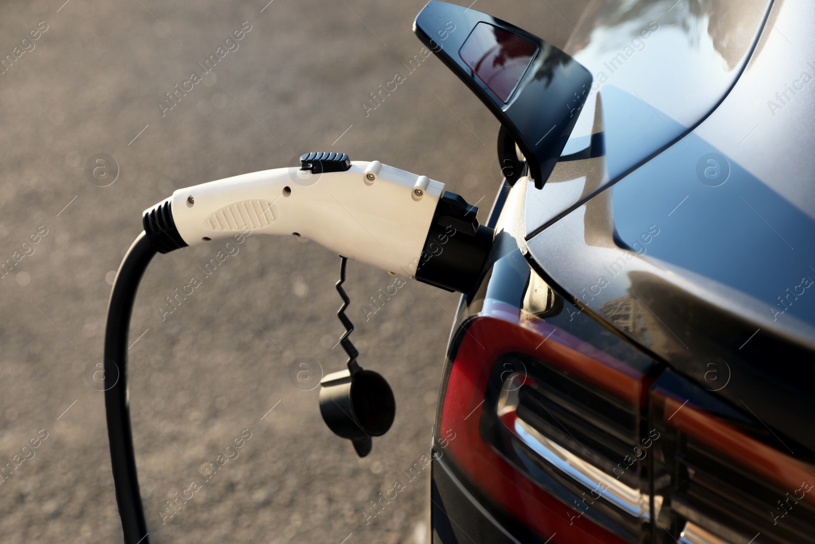 Charging modern electric car from station outdoors, closeup Photo of Charging modern electric car from station outdoors, closeup