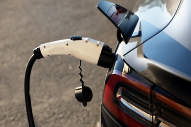Charging modern electric car from station outdoors, closeup Photo of Charging modern electric car from station outdoors, closeup