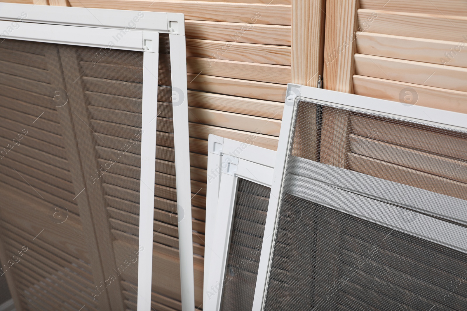 Set of window screens near wooden folding screen Photo of Set of window screens near wooden folding screen