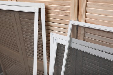 Set of window screens near wooden folding screen Photo of Set of window screens near wooden folding screen