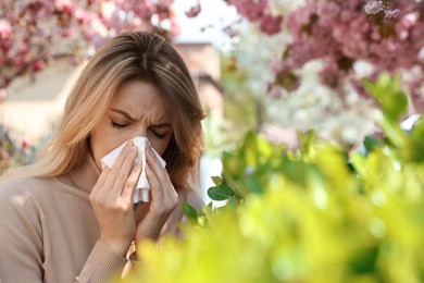 Woman suffering from seasonal pollen allergy outdoors Photo of Woman suffering from seasonal pollen allergy outdoors